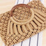 Close-up of camel cotton crochet handbag with round wooden ring handles.