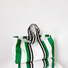 Large canvas tote bag with vibrant green and white vertical stripes.