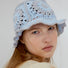 Model wearing blue Floral Crochet Hat. Bright cheerful patterns in a premium polyester-cotton blend.