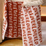 Close-up do full of love bath towel with repeating red lover text.