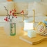Lifestyle view of Green Frosted Vase with lamp and wooden tray beside.