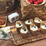 Angled view of Hand Woven Rattan Tray with cupcases on it, easy for parties and everyday use.