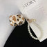 Flat lay of Leopard Print AirPods Case Cover with pearl string, great for daily protection and travel.