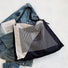 Monochrome geometric nylon bag showing the sturdy straps and smooth texture.