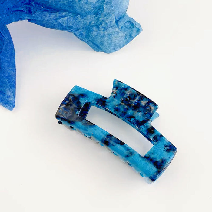 Angled view of blue Midnight Ice Hair Claw in large rectangle shape.