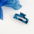 Angled view of blue Midnight Ice Hair Claw in rectangle shape.