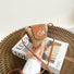 Model holding a small  size of Mini raffia straw bucket crossbody bag, easy for commuting and weekends.