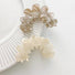 Grey and white Moon Hair Claws shown together, ideal for quick updos and ponytails.