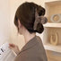 Model wearing a coffee brown Plush Hair Claw, easy for workdays and special.