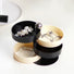 Detailed view of  black and white Multilayer Storage Box with each layer fanning out in an alternating pattern.