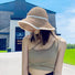 Model wearing breathable straw sun hat with pearl accent providing stylish shade for poolside relaxation and picnics.