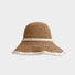 Front view of khaki straw hat and shimmering pearl band presenting elegant coastal accessory.
