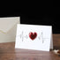 Flat lay of embossed Red Love Card, perfect for gifting.