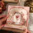 Model Hands holding a  Rose Poetry Greeting Card with roses pattern.