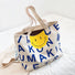 Folded view of Smile Face Canvas Tote Bag in blue, easy for commuting and weekends.
