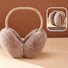 Angled view of nude pink faux fur earmuffs; showcasing the high-loft cozy aesthetic.