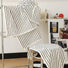 White cotton stripe face towel and bath towel set, hanging and folded on chrome racks.