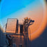 Sunset/Daybreak lamp casting warm, colorful light onto a wall with inspirational text and decorative items.