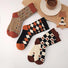 Angled view of Three pairs of retro cotton-acrylic socks with unique patterns: hearts, argyle and grass.