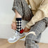 Model wearing a pair of Thick Retro Socks in checkered pattern, easy to pack for travel and errands.